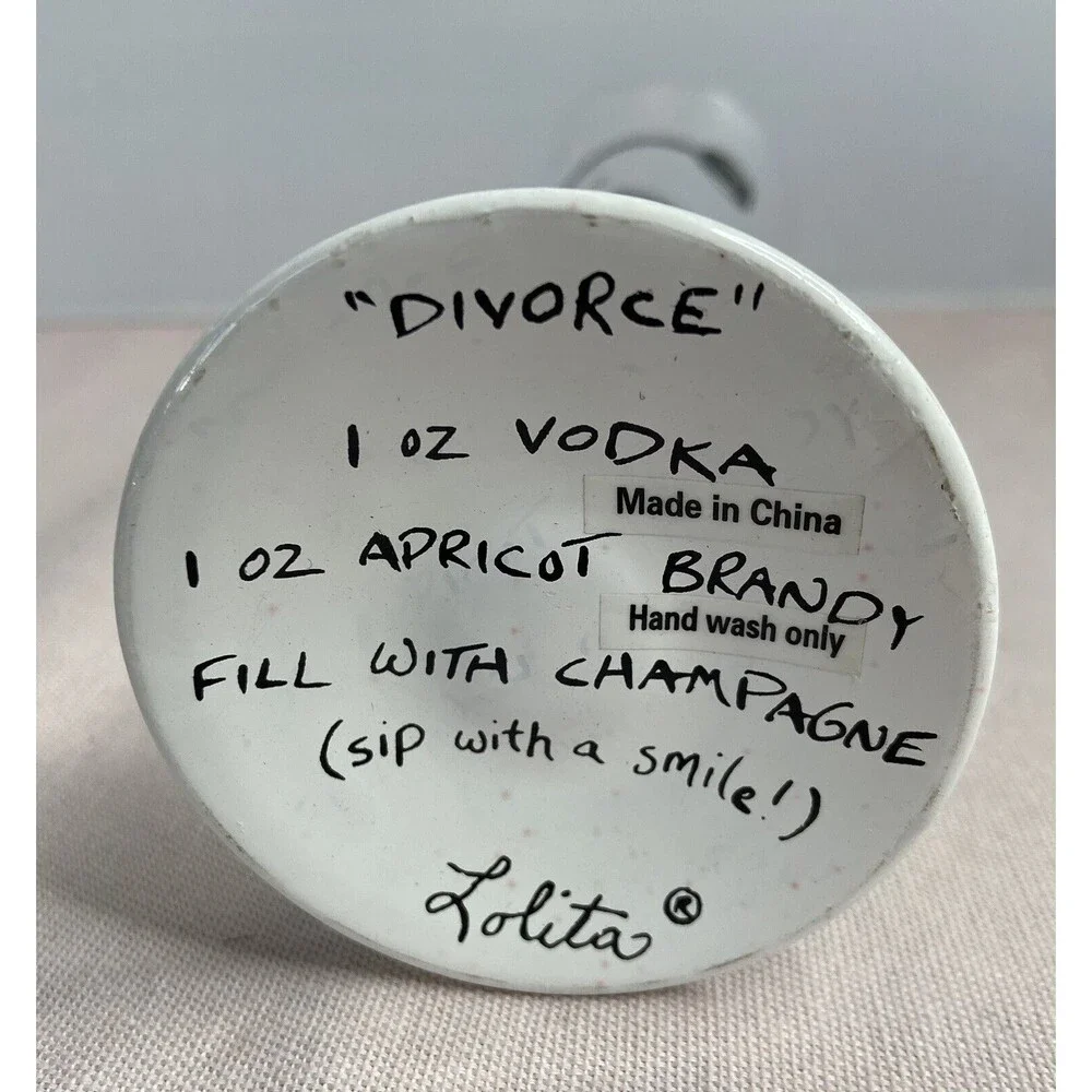 LOLITA - DIVORCE CHAMPAGNE FLUTE  GLASS HAND PAINTED. SOME PAINT WEAR ON GLASS.